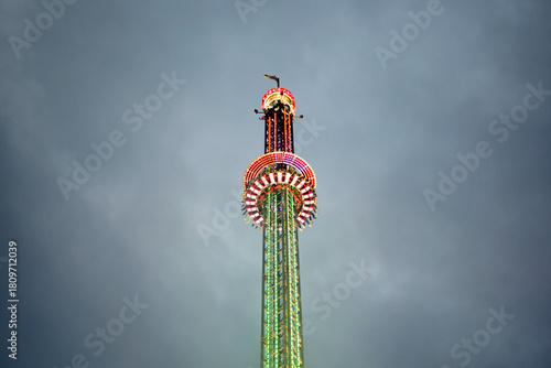 Colorful drop tower Ride against stormy sky