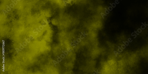 Yellow color powder explosion cloud isolated on black background.  dust smoke . Yellow dust particles explosion background .