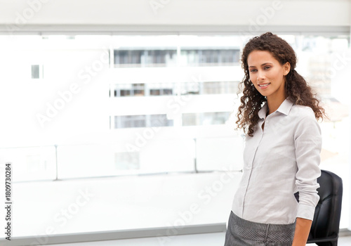 Adult woman leaning on black chair by large windows in light shirt, gray skirt, copy space Free Download Adult woman leaning on black chair by large windows in light shirt, gray skirt, copy space - GFXLoad