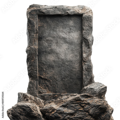 A rough stone tablet stands on a rocky base against a dark background