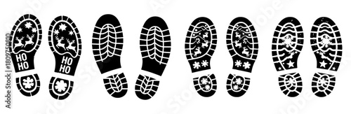 Footprints with christmas and winter themed designs in black and white on a white isolated background