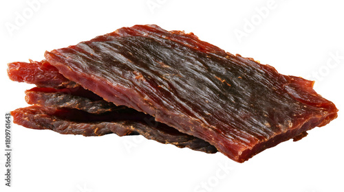 Two slices of dried beef jerky isolated on a white background, a cured meat snack, a savory protein food ingredient, a salty dehydrated steak strip, a tasty appetizer concept.