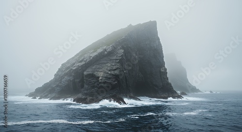 Majestic Rocky Island Surrounded by Ocean in Misty Weather