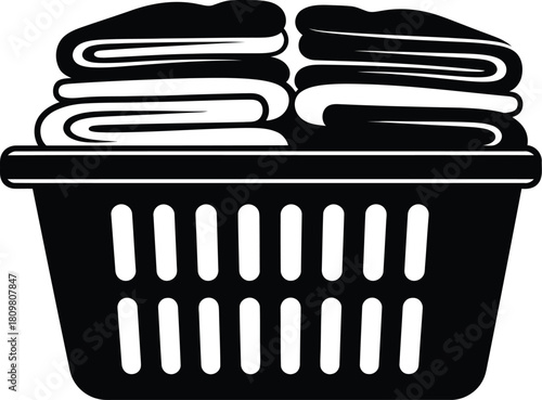 Black laundry basket with folded clothes for washing and cleaning service