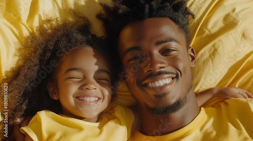 Happy african family moment: smiling father and daughter in yellow clothing