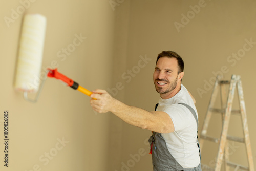 Man happily painting a wall...
