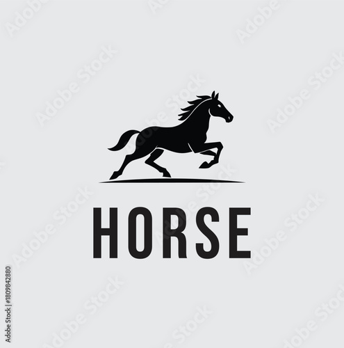 A strong, minimalist black silhouette of a horse in a powerful gallop or run, symbolizing freedom, speed, strength, and dynamic movement.