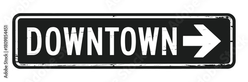 Distressed black and white downtown directional sign with arrow