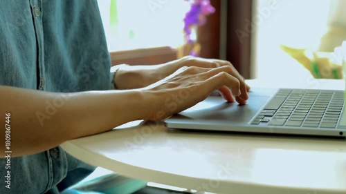 close-up female hand touching touchpad on a laptop computer