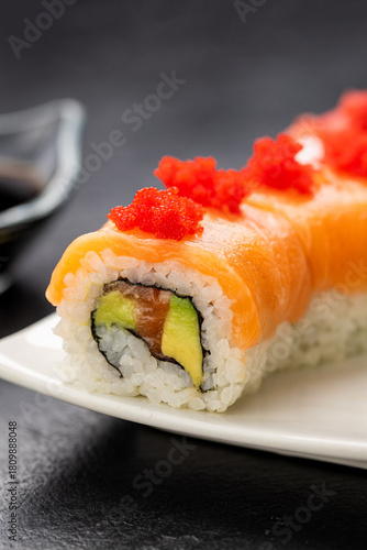 Wallpaper Mural Salmon sushi roll with red roe on white plate, soy sauce, wasabi and ginger, top view Torontodigital.ca