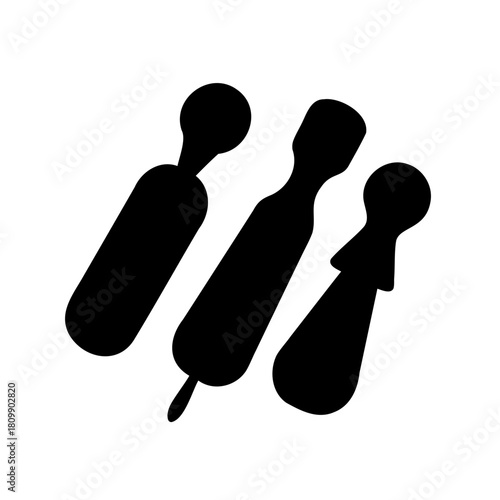 Stylized silhouette icon of three cloves for spice concept