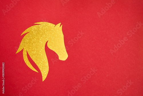 Golden horse silhouette on red background. Symbol of prosperity and strength in festive Chinese New Year 2026
