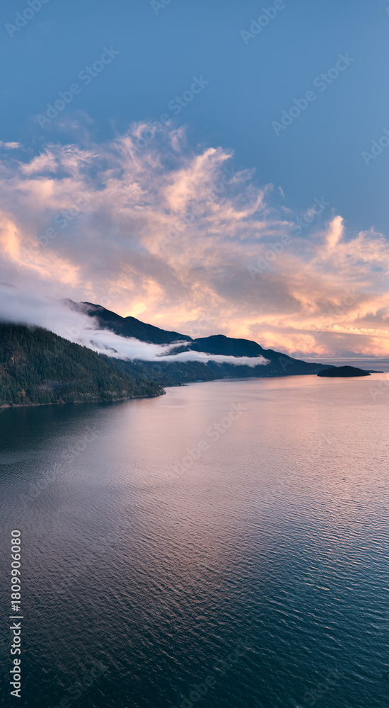 Fototapeta premium Sunset Over Coastal Mountains in British Columbia, Canada, Calm Water and Mist at Dusk