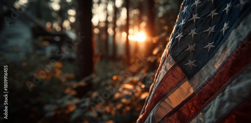 Sunset Shines Through Trees Highlighting a Worn American Flag in a Peaceful F...