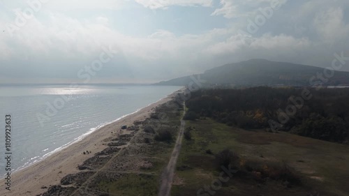 Wallpaper Mural Aerial drone view of foggy coastline with mountains, calm sea, long sandy beach, soft clouds, peaceful atmosphere and natural coastal landscape. Torontodigital.ca