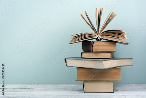Stack of colorful books. Education background. Back to school. Book, hardback colorful books on wooden table. Education business concept. Copy space for text.