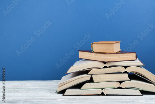 Open book, hardback colorful books on wooden table. Back to school. Copy space for text. Education business concept.