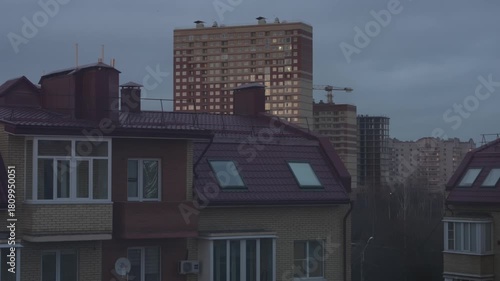 House, sunset, evening, time, sun, clouds, sky. Construction, tower crane, new building.