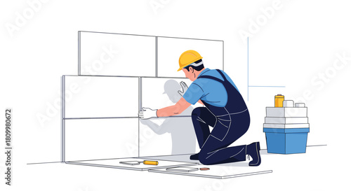 Professional construction worker in a hard hat and overalls carefully installing large white ceramic tiles on a wall at a job site.