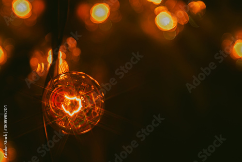 Background - electric garland with incandescent bulbs, yellow warm light