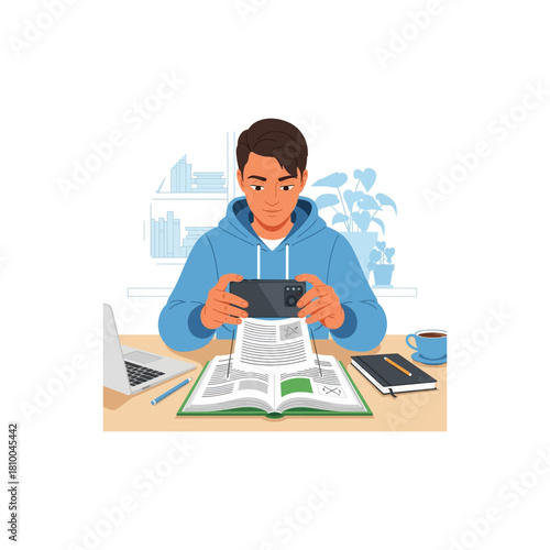 A young male student in a blue hoodie uses his smartphone to scan a page from an open book at his desk.