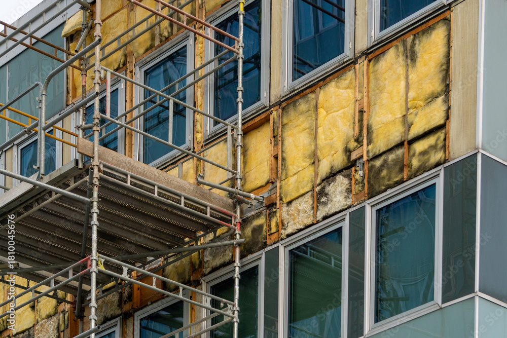 Fototapeta premium Building Facade Renovation: Scaffolding, Exposed Insulation, and Modern Windows