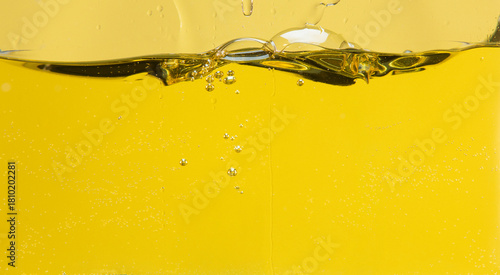 Side cut image of oil with bubbles and waves in a container