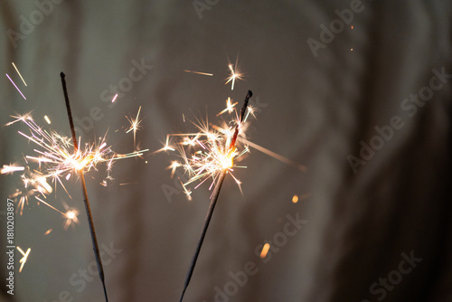 holding sparklers in hand holiday background