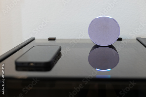 person controls smart wireless device with cell phone at home