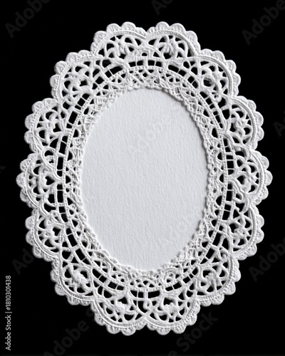 Oval white lace doily with open center on black background