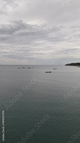 Aerial video taken with a drone in vertical format on Santa Clara beach on a cloudy day by the Pacific Ocean, in the province of Coclé, in Río Hato, Panama.