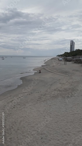 Aerial video taken with a drone in vertical format on Santa Clara beach on a cloudy day by the Pacific Ocean, in the province of Coclé, in Río Hato, Panama.