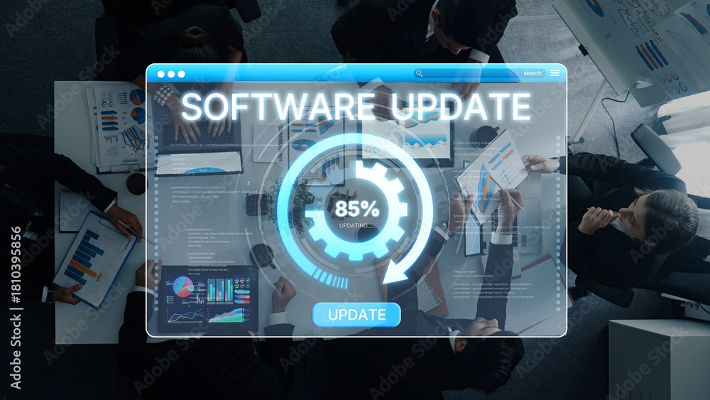 Fototapeta premium A high-tech meeting scene showing professionals collaborating on a software update. Digital interface displays analytics and progress, highlighting teamwork and innovation. Trope