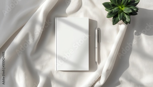 Clean minimal book 4x6 mockup on cloth with plant and pen background