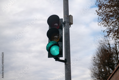 traffic light, road sign with green shape and light, indicates the right to cross the road at an intersection. The green light is an ok today also associated with saying ok go ahead!