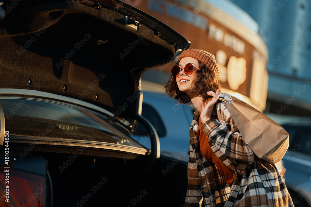 © SHOTPRIME STUDIO - Woman by car trunk with bag and sunglasses wearing beanie and plaid coat, golden hour candid lifestyle portrait capturing authenticity, mindful living and emotional storytelling glow.