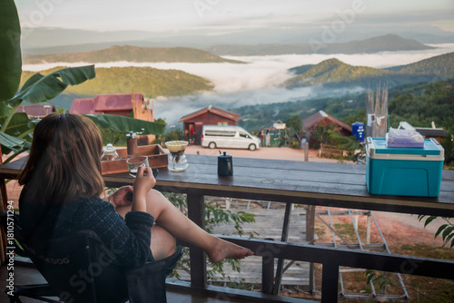 Woman Drinking Coffee with Mountain View