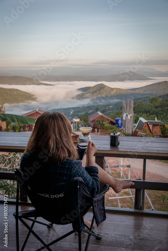 Woman Drinking Coffee with Mountain View