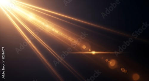 Golden light rays shining down diagonally on a dark background with bokeh