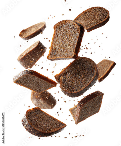 Sliced dark bread pieces suspended mid-air on black