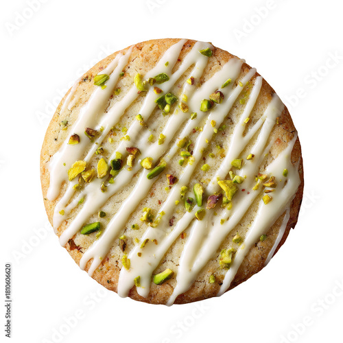 Round cookie, white drizzle, green pistachio bits, top view