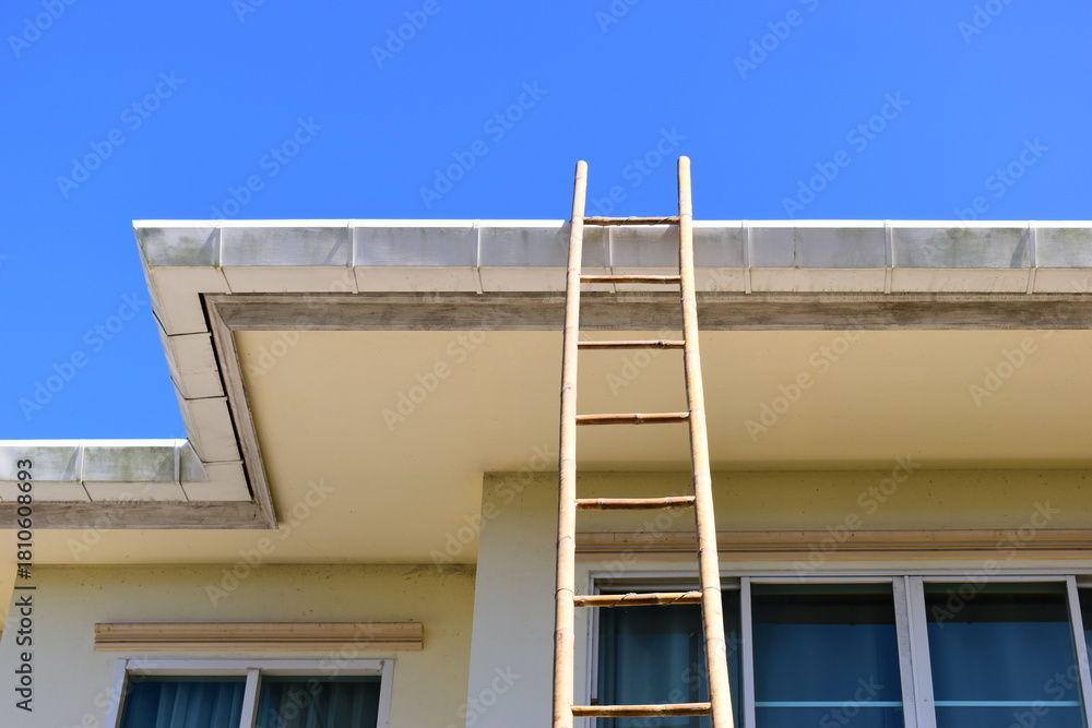 Fototapeta premium wood ladder for repair house's gutter before rainy season