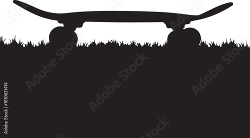 Black skateboard silhouette on grass wheels