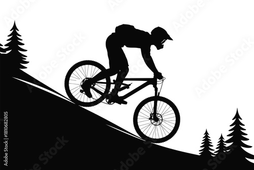 Mountain biker descending steep slope among pine trees mountain biking downhill