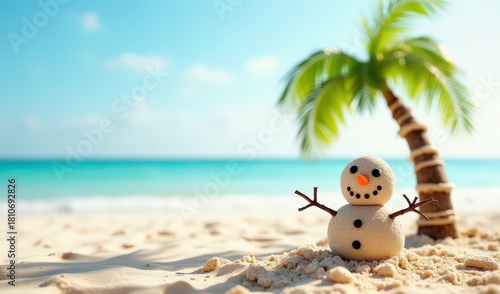 A sand snowman stands on a tropical beach with a palm tree and turquoise ocean under a clear blue sky