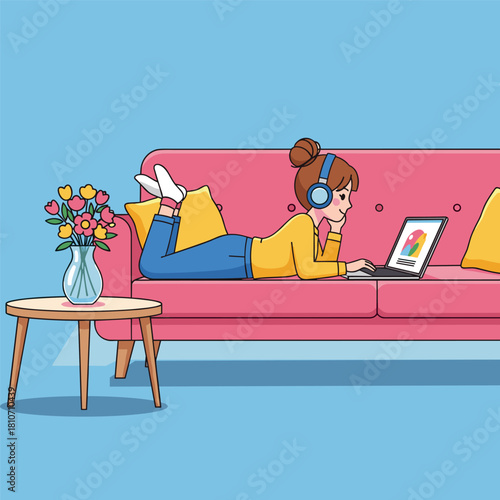 Cartoon girl with headphones lying on a pink sofa using a laptop next to a small table with a vase of flowers