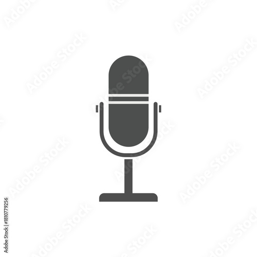 Monochromatic dark grey silhouette vector icon of a classic studio condenser microphone on a stand, symbolizing recording, broadcasting, podcasting, voice communication, and audio media production.