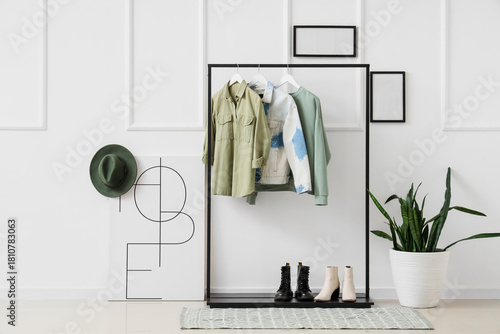 Black rack with stylish clo...