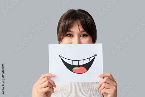 Young woman with paper smil...