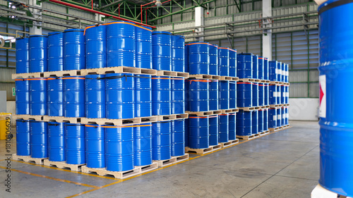 chemical barrels on wooden pallets, organized warehouse storage, industrial drums ready, safe chemical handling, shipment preparation